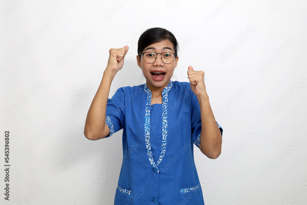 Fototapeta premium Happy young asian woman standing with clenched hand. Success concept. Isolated on white background