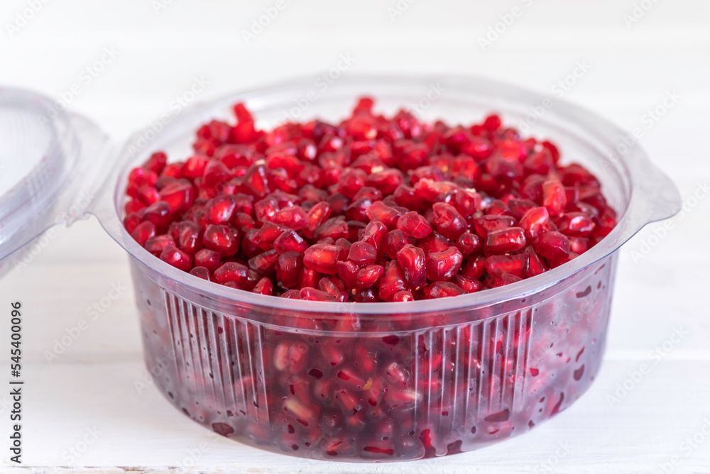 Pomegranate seeds in plastic box. Pomegranate seeds in plastic box.