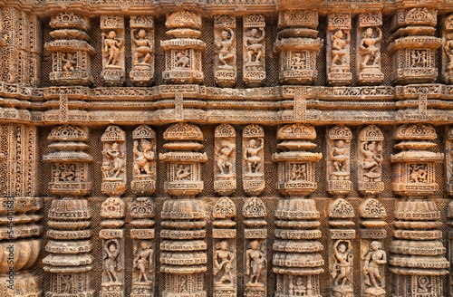 Konark sun temple wall with stone sculptures, carvings and artwork from the 13th century at Puri, Odisha, India photo