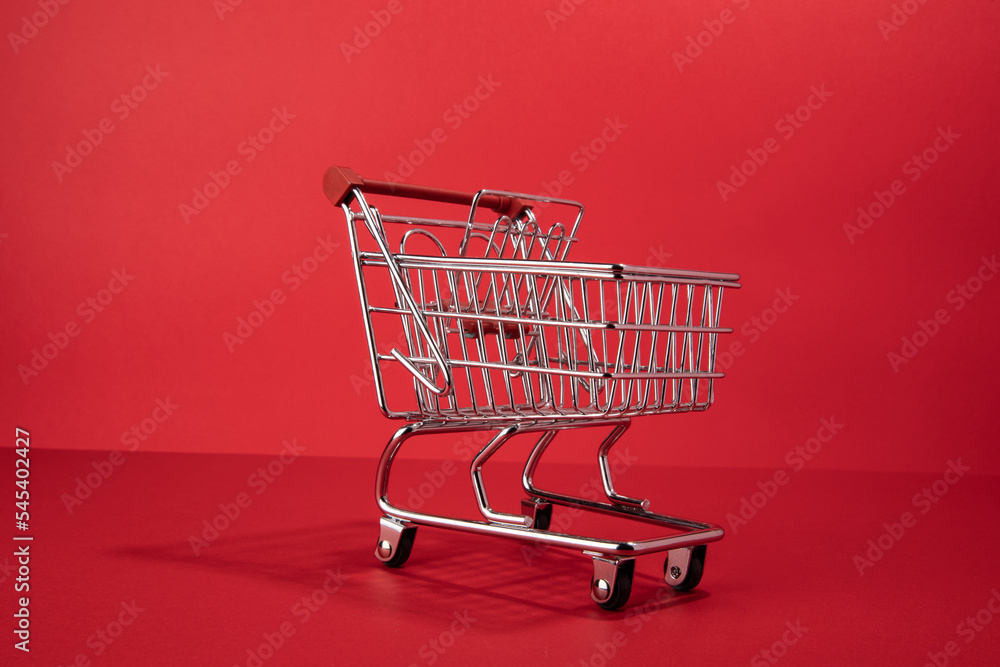 red empty shopping cart on red background red empty shopping cart on red background