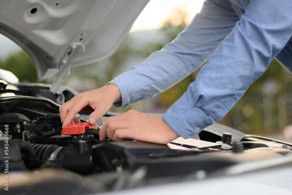 man checking the engine of a car man checking the engine of a car