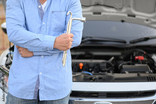 man holding car fixing equipment after fixing