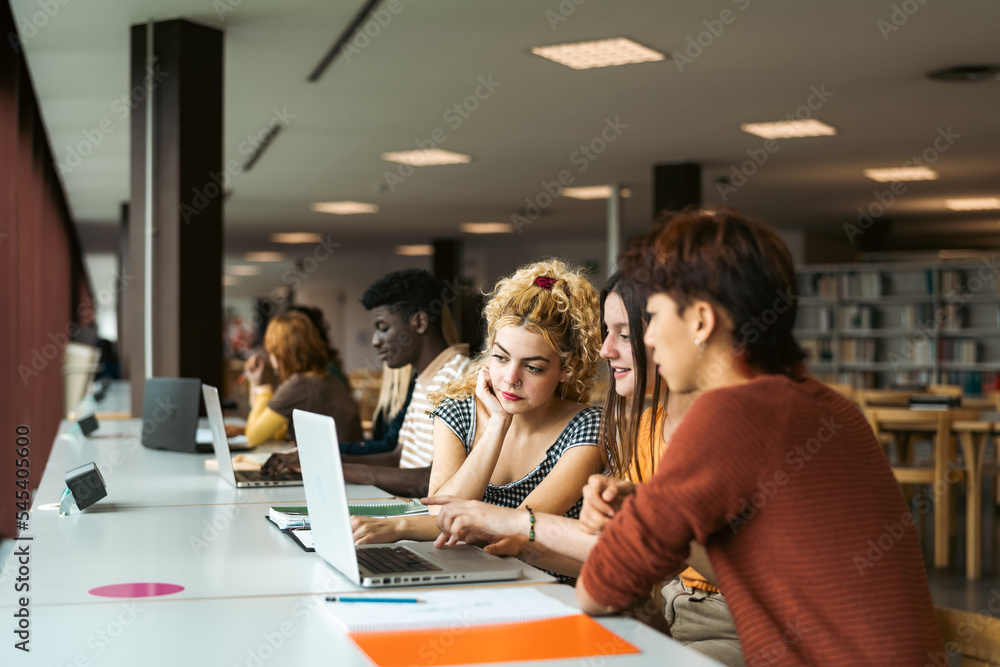Young multiracial people studying in library - School education concept Young multiracial people studying in library - School education concept