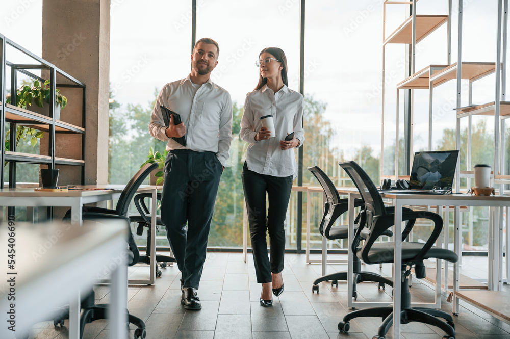Front view. Man and woman are working in the modern office together Front view. Man and woman are working in the modern office together