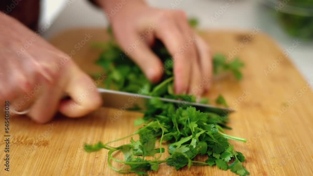 Woman cutting parsley salad at the kitchen Woman cutting parsley salad at the kitchen