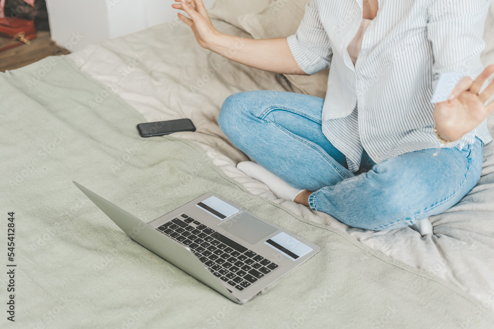 Naklejka premium Woman at home on bed makes purchases on the Internet. The joy of the black friday sale. 
