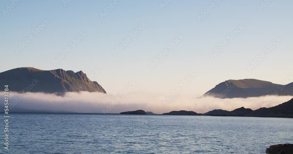 Mountain landscape scenic view with slowly moving low clouds. Lofoten Islands, sunny morning and beautiful nature in the Norway fjords. Copy or text area on the sky.
Mountain landscape scenic view with slowly moving low clouds. Lofoten Islands, sunny morning and beautiful nature in the Norway fjords. Copy or text area on the sky.