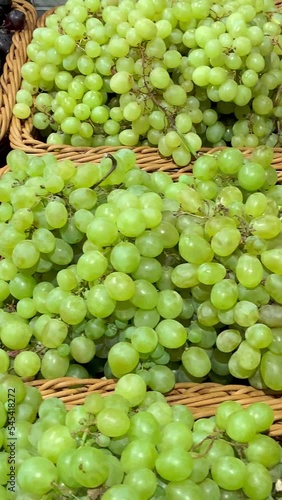 Showcase with punnets different sorts grapes. photo