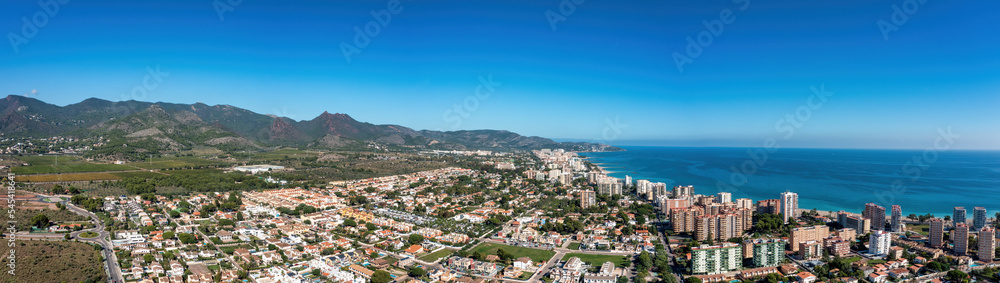 Panorama and Areal View of Benicàssim, a municipality and beach resort located in the province of Castelló, on the Costa del Azahar in Spain Panorama and Areal View of Benicàssim, a municipality and beach resort located in the province of Castelló, on the Costa del Azahar in Spain