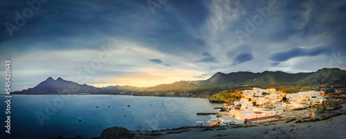 relaxing panoramic view of the sunset over the sea and the quiet village of la isleta del moro in the natural park of cat cape