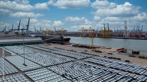 Aerial view vehicle carrier vessel loading car for shipping to worldwide, Large RoRo (Roll on off) vehicle car carrier, New car lined up in the port for import export around the world.