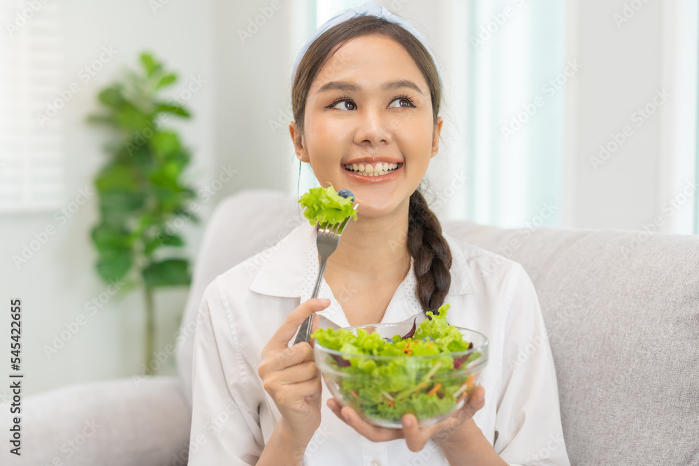 Diet, Dieting pretty attractive asian young woman, girl use fork at lettuce on mix vegetables, green salad bowl, eat food is low fat to good body. Nutritionist female, Weight loss for healthy person. Diet, Dieting pretty attractive asian young woman, girl use fork at lettuce on mix vegetables, green salad bowl, eat food is low fat to good body. Nutritionist female, Weight loss for healthy person.