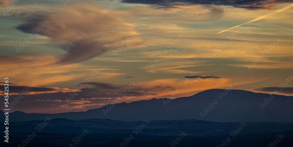 Spectacular cloudy sunset over the mountains (Granada, Spain) in autumn
