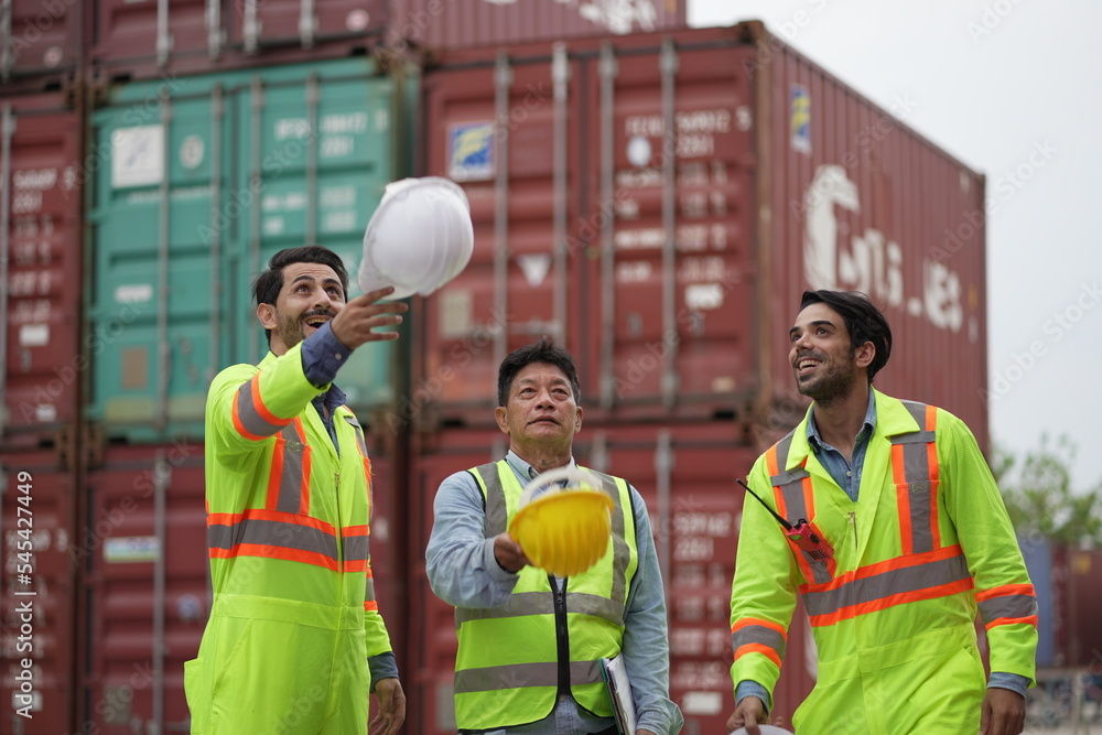 Dock worker man in safety vest work in container port terminal. male Industrial Engineer in Hard Hat, High-Visibility Vest Working. Inspector or Safety Supervisor in Container Terminal. shipping yard. Dock worker man in safety vest work in container port terminal. male Industrial Engineer in Hard Hat, High-Visibility Vest Working. Inspector or Safety Supervisor in Container Terminal. shipping yard.