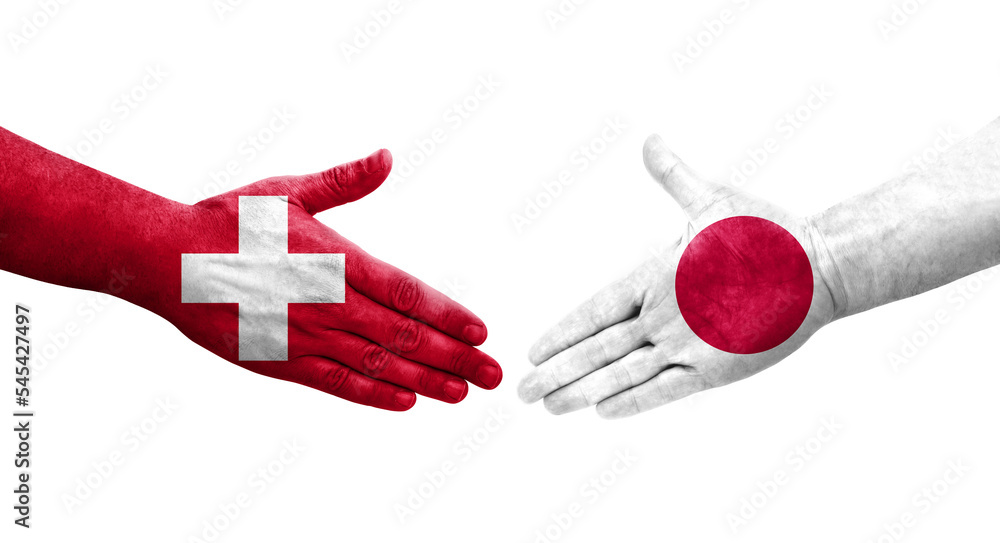 Fototapeta premium Handshake between Switzerland and Japan flags painted on hands, isolated transparent image.