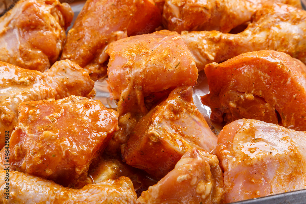 chicken parts in soy sauce and spices marinated on foil. chicken parts in soy sauce and spices marinated on foil.