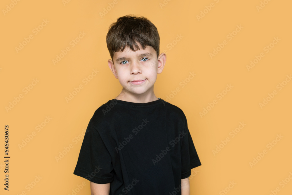 A handsome but a little sad boy of early school age in a black T-shirt, he has a serious tired look, he wants to go on vacation, rest from the comments of teachers and parents A handsome but a little sad boy of early school age in a black T-shirt, he has a serious tired look, he wants to go on vacation, rest from the comments of teachers and parents
