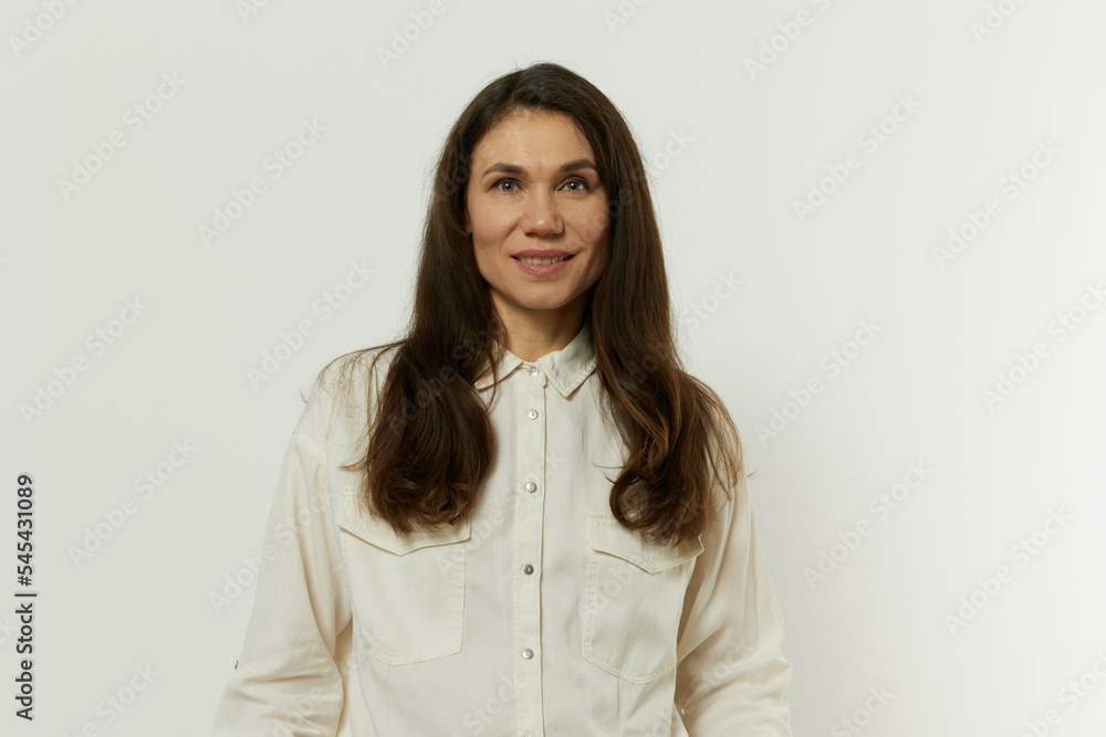 portrait of a beautiful happy attractive adult woman in a white shirt on a white background portrait of a beautiful happy attractive adult woman in a white shirt on a white background