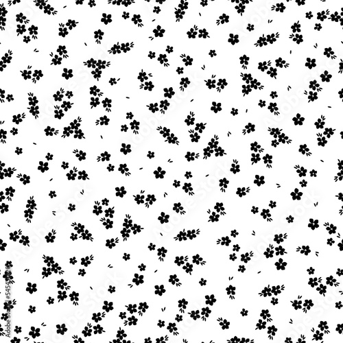 Cute floral pattern. Seamless vector texture. An elegant template for fashionable prints. Print with small black flowers and leaves. white background.