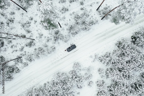 High angle of a car driving in between the snow