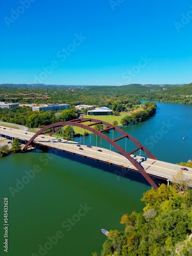 Vertical shot of cars driving on Pennybacker Bridge over the lake in Austin, Texas photo