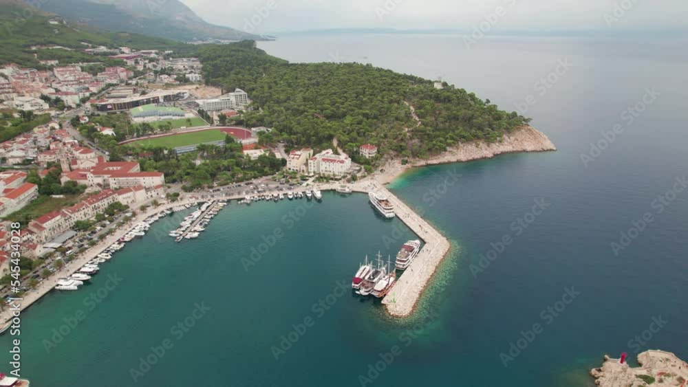 Makarska Croatia High angle Panning drone shot ,beach and town summer day blue sky Makarska Croatia High angle Panning drone shot ,beach and town summer day blue sky