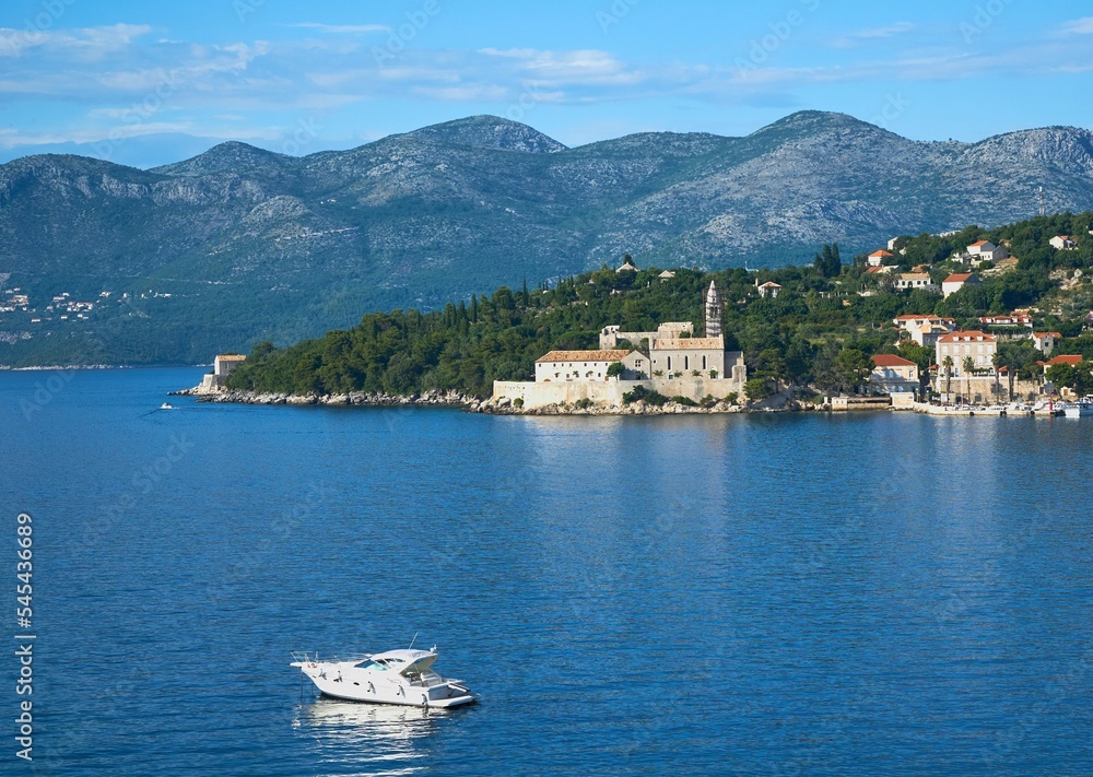 Scenic view of a blue seascape and mountains in the background on Lopud Island, Croatia Scenic view of a blue seascape and mountains in the background on Lopud Island, Croatia