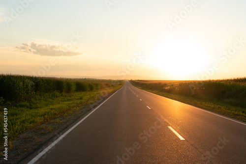 Beautiful orange sunset over the empty road with soft selective focus. Beauty of nature concept