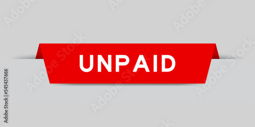 Red color inserted label with word unpaid on gray background