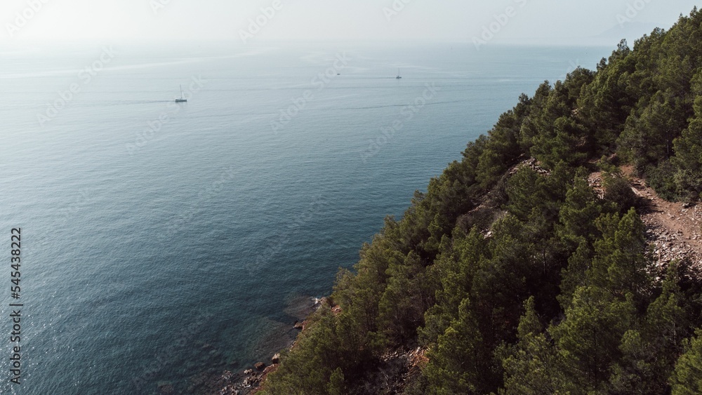 Aerial view of an island with green and overlooking blue ocean Aerial view of an island with green and overlooking blue ocean