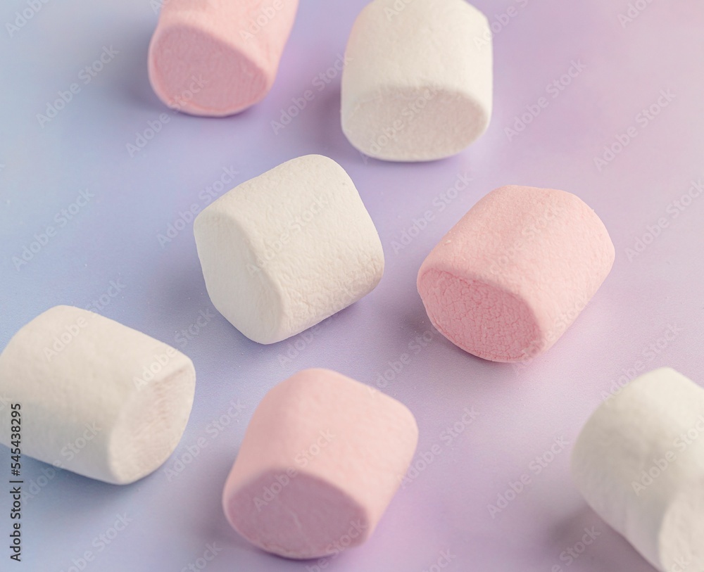 Close-up shot of marshmallows on a pink and purple background Close-up shot of marshmallows on a pink and purple background