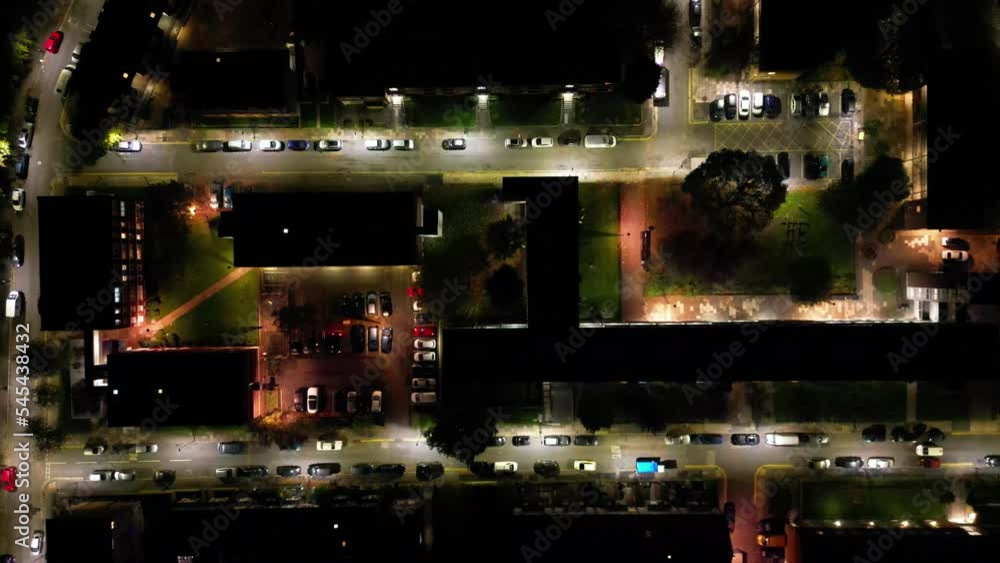 Aerial view slowly zooming out over parked and moving cars in north London at night Aerial view slowly zooming out over parked and moving cars in north London at night