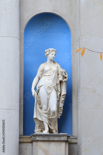 Amsterdam Historic Canal House Garden Statue of Goddess Flora in a Blue Niche with Yellow Autumn Leaves, Netherlands