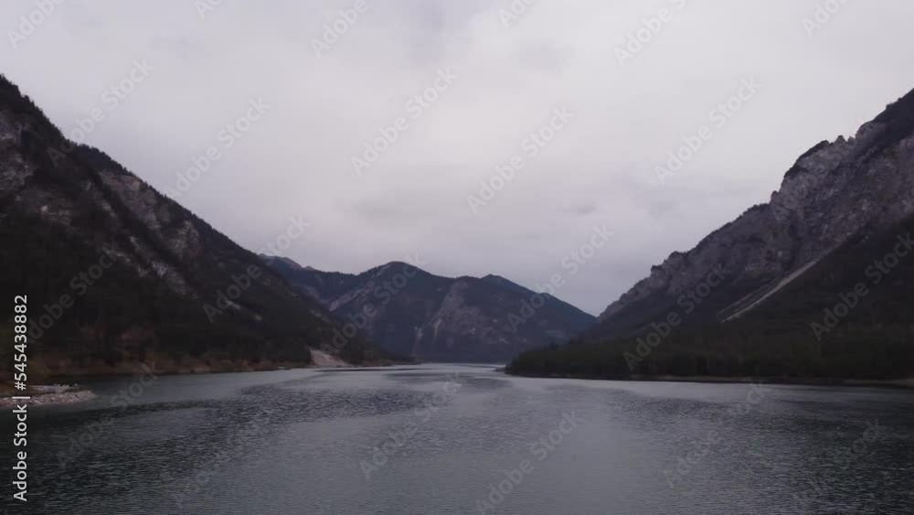Aerial of the blue Plansee lake near Breitenwang, Germany with the background of high mountains Aerial of the blue Plansee lake near Breitenwang, Germany with the background of high mountains