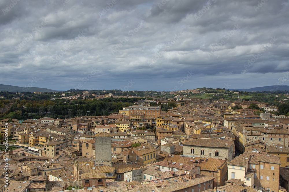 Scenery of Siena, a beautiful medieval town in Tuscany, landmark Mangia Tower and Basilica of San Domenico, Italy