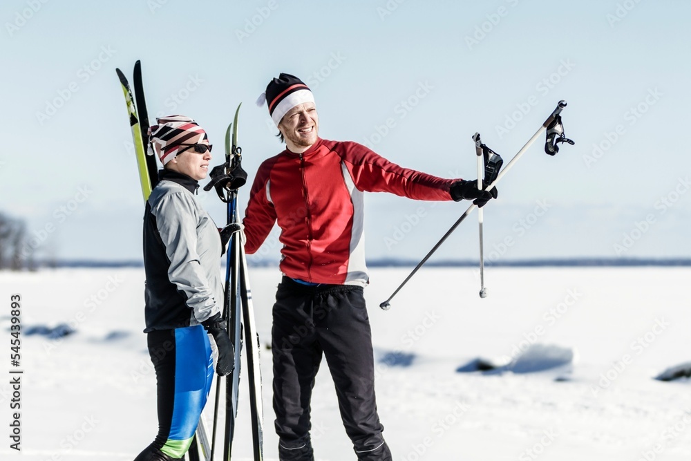 Male and female athletes cross-country skiing. Male and female athletes cross-country skiing.