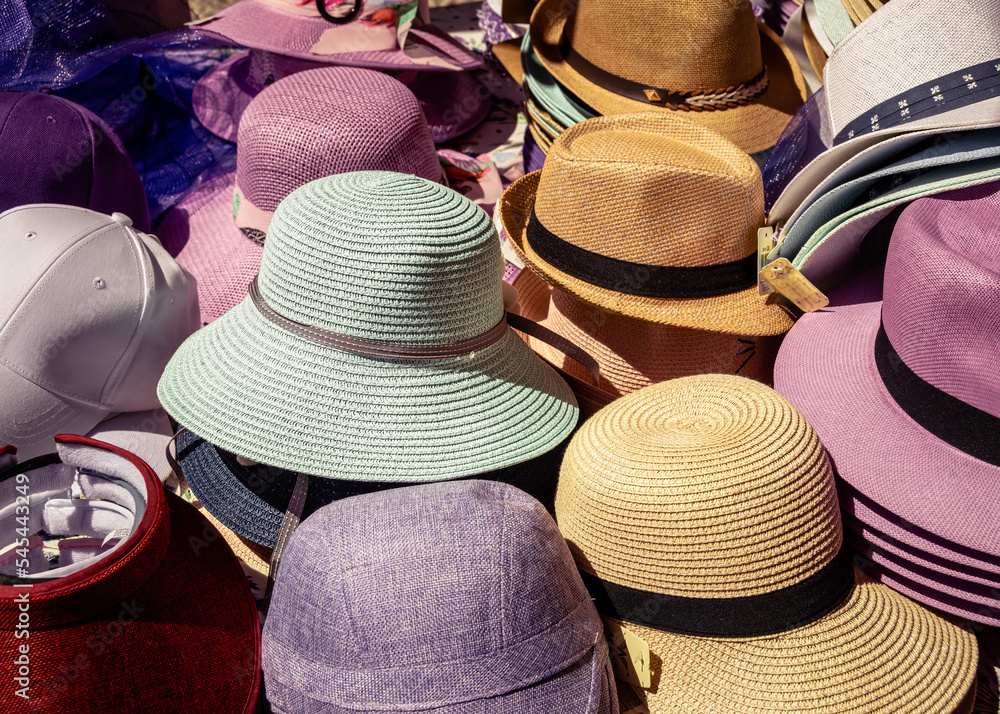 Straw sun hats on a street market at Brihuega July Lavander festival