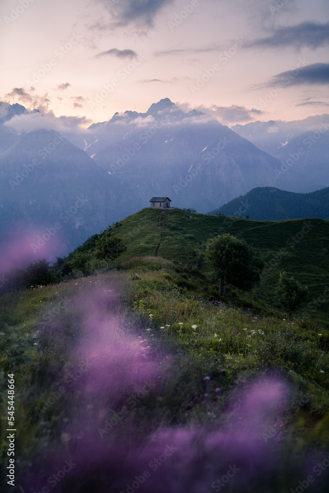 The iconic chapel located on top of Manina Pass during blue hour in the Orobie Alps, Northern Italy