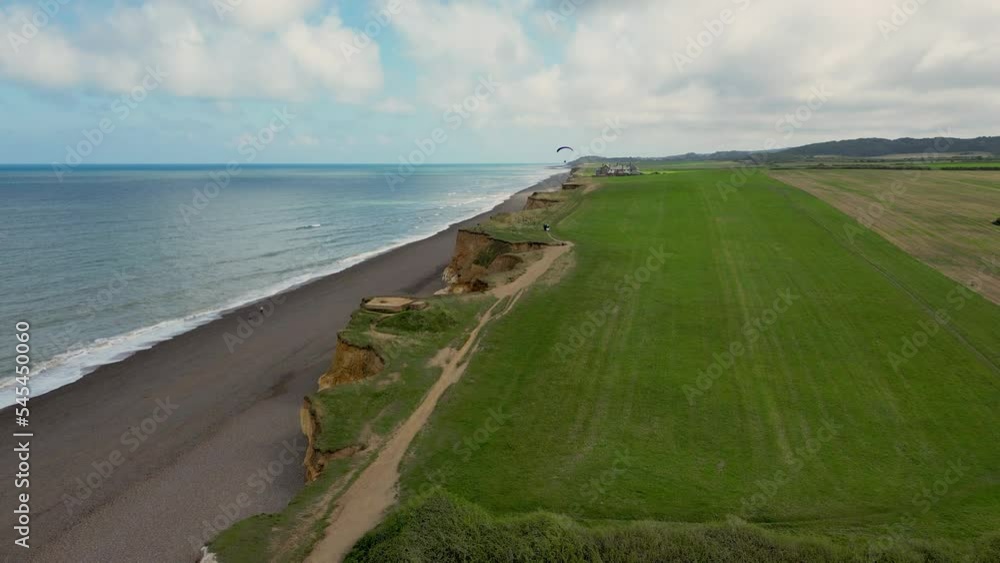 Scenic view of a person paragliding at the beautiful Weybourne beach Scenic view of a person paragliding at the beautiful Weybourne beach