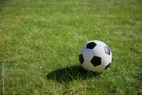 Football ball in the green field