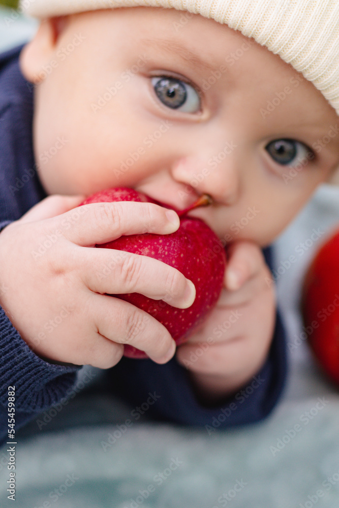 Portrait of cute adorable smiling child kid sitting eating apple fruit Portrait of cute adorable smiling child kid sitting eating apple fruit