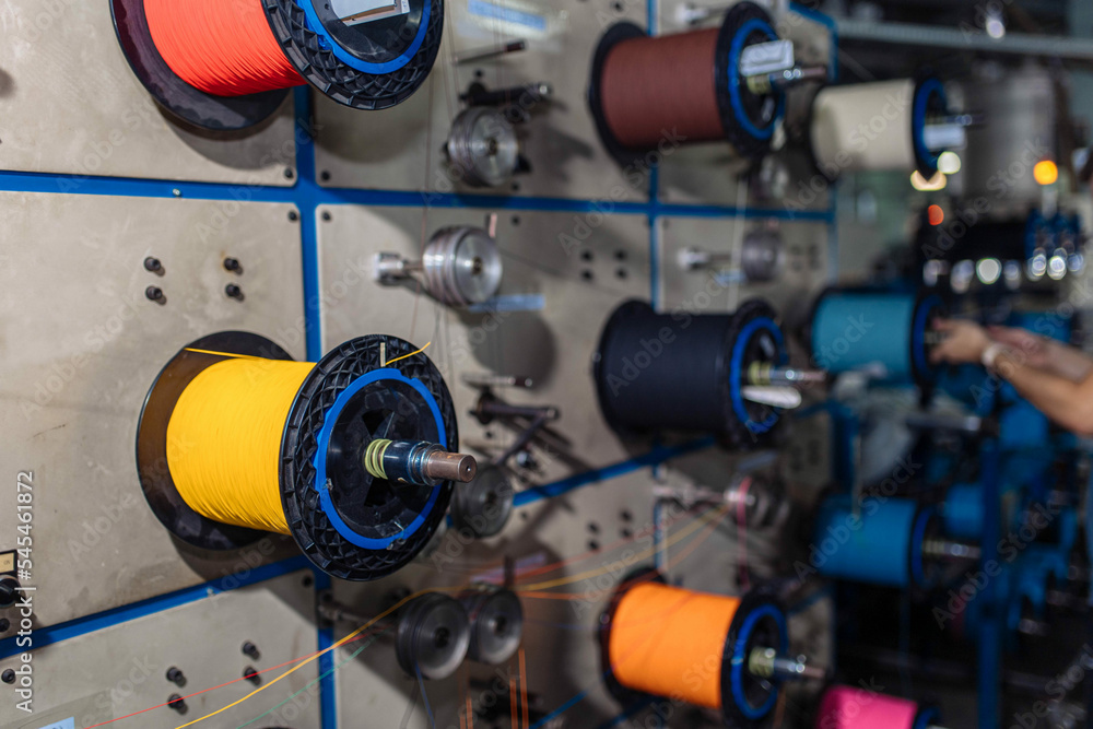 production of glass fiber fiber optic cable in the factory, Internet telecommunications wires in coils.