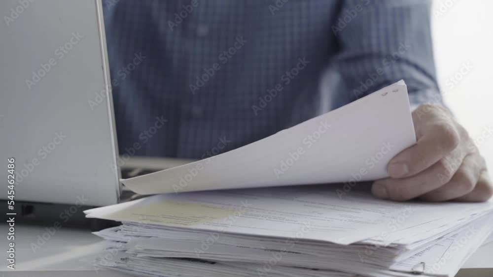 The hands of a clerk sitting at his desk holding a mug. The hands of a clerk sitting at his desk holding a mug.