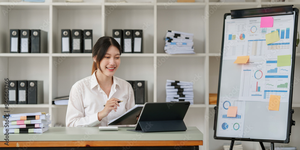 Pleasant positive business woman using digital tablet at home office