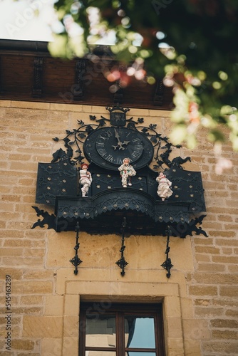 Vertical shot of the clock chimes on the city hall in Laguardia, Alava, Spain photo