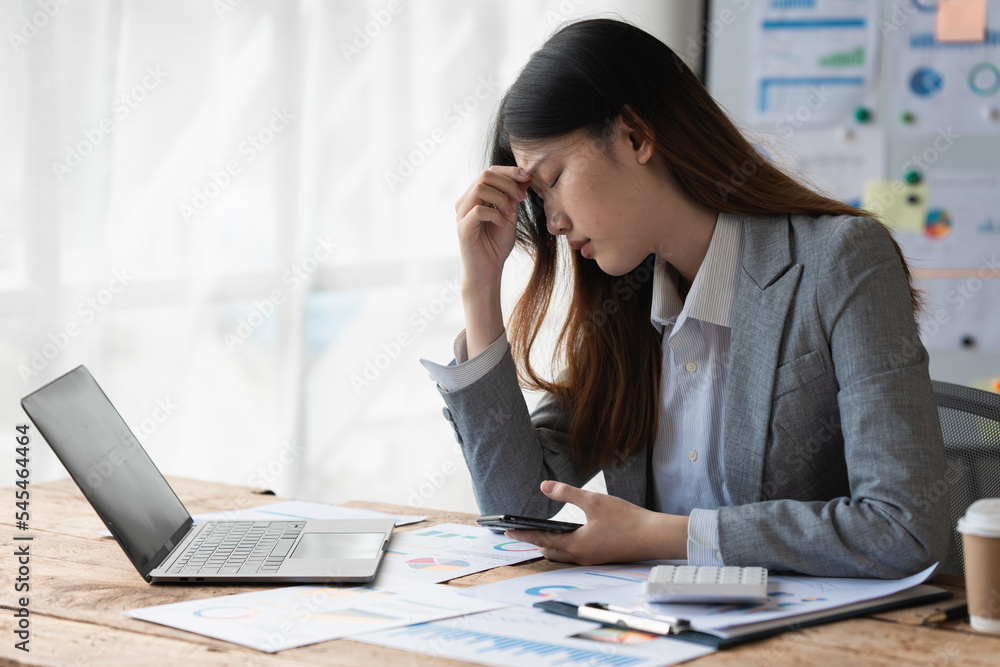Stressed Asian business woman worry about marketing plan of this years. Account, Real Estate Agent, Finance concpet Stressed Asian business woman worry about marketing plan of this years. Account, Real Estate Agent, Finance concpet