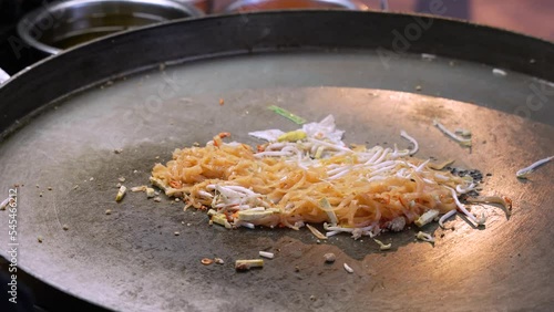 Pad Thai Bangkok Street food being cook on a flat Thai Wok