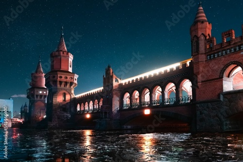 Scenic view of Oberbaum Bridge in Berlin, Germany with a starry night in the background