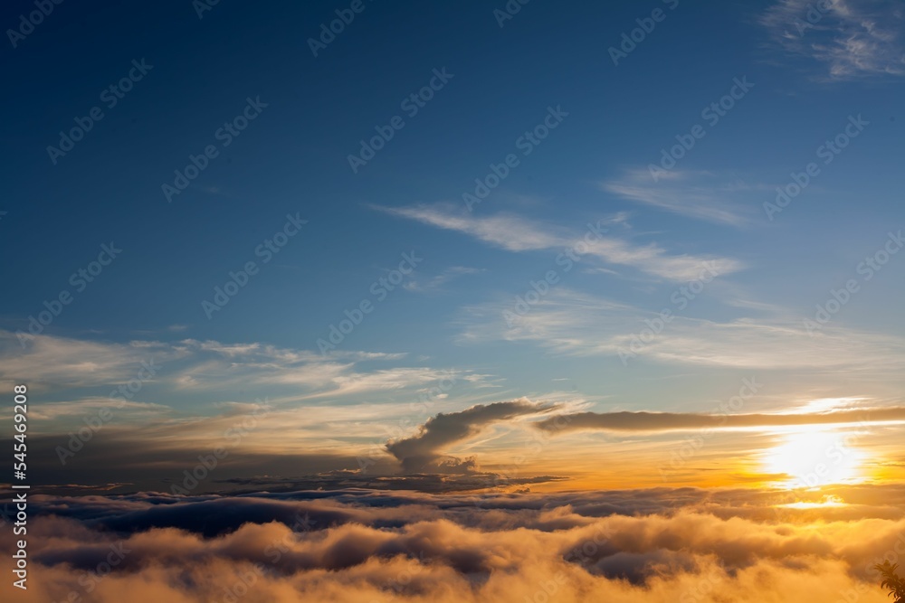 Beautiful scene of sunset white clouds in the blue sky with orange sky