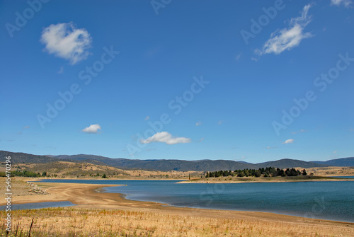 Jindabyne, New South Wales, Australia: View over Lake Jindabyne with trees, sky and cloud. Jindabyne is a tourist destination near the Snowy Mountains.